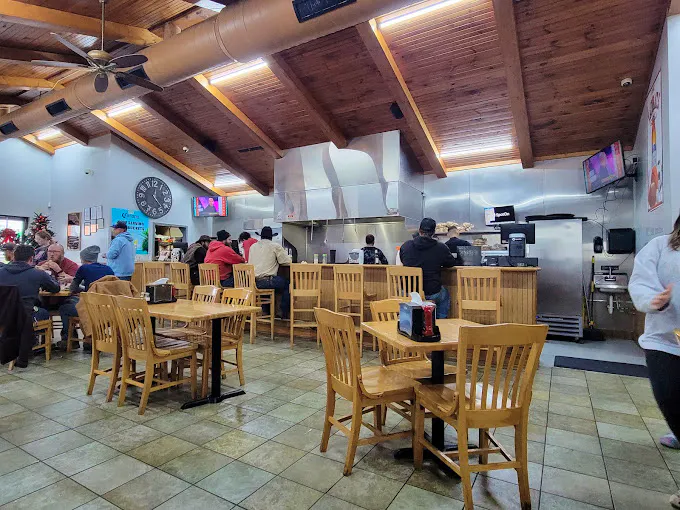 Inside of a Tailgate Grill with a counter, dining area, and kitchen.